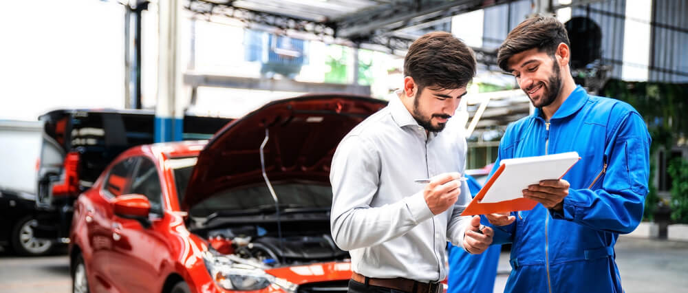 Man reviewing the car repair budget with the mechanic
