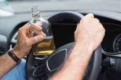 Man drinking alcohol while driving in his car - Acceptance, cheap business insurance