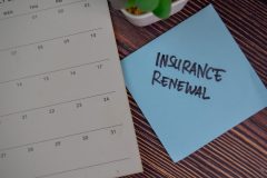 Image of a calendar and a sticky note with the words Insurance Renewal written on it.