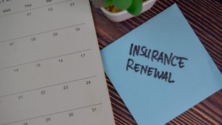 Image of a calendar and a sticky note with the words Insurance Renewal written on it.