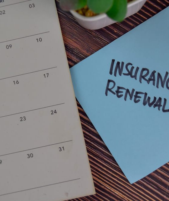 Image of a calendar and a sticky note with the words Insurance Renewal written on it.