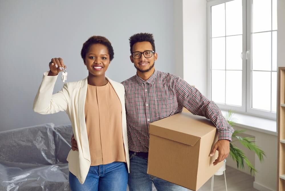 Black couple moving into their first home and buying homeowners insurance.