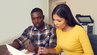 Bi-racial couple decides on their home insurance coverage.