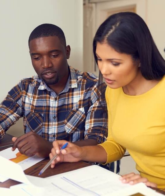 Bi-racial couple decides on their home insurance coverage.