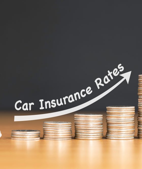 Increasing stacks of coins with a car at the beginning and an arrow going up, concept of increasing car insurance prices - cheap car insurance in California.