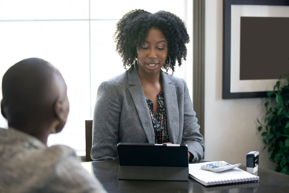 Woman insurance agent works with male customer who has bad credit - cheap car insurance even with bad credit.