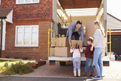 Family loads up moving van in preparation for a move - cheap car insurance.