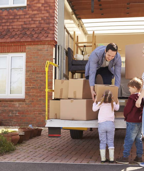 Family loads up moving van in preparation for a move - cheap car insurance.