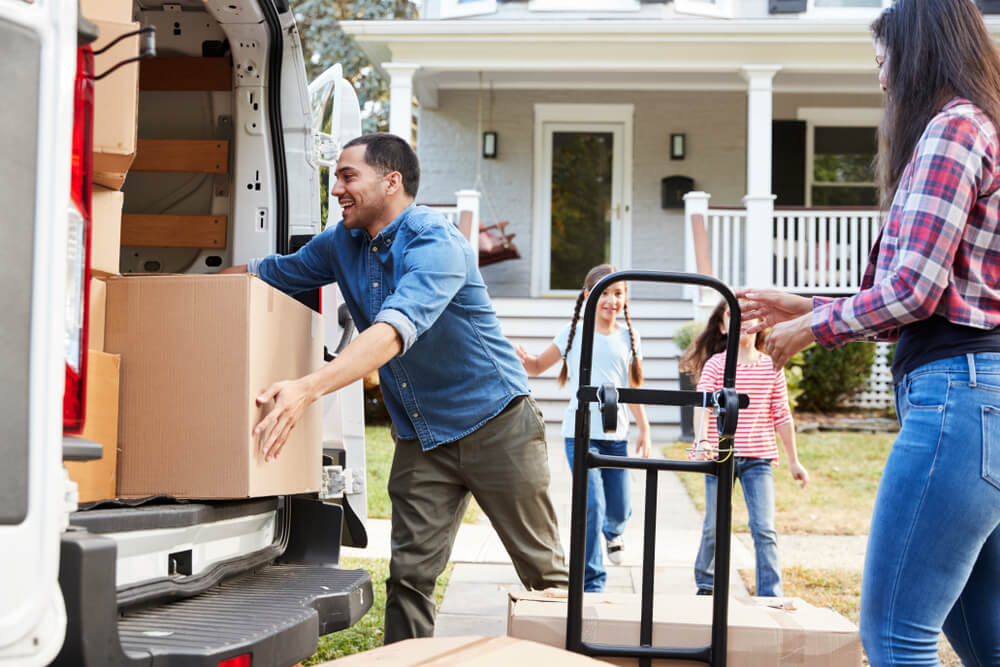 Family of four helps unload the moving van after relocating - cheapest car insurance.