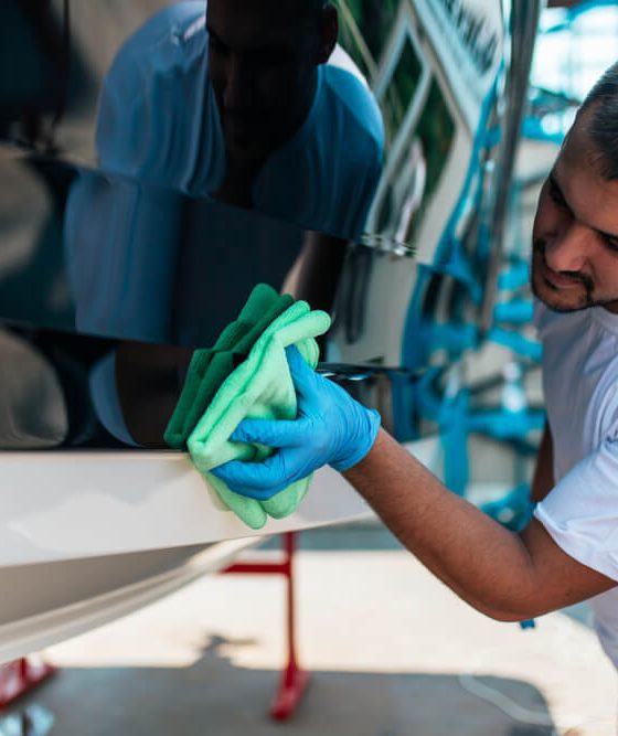 Man scrubbing his boat in preparation for spring season - cheap boat insurance.