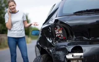 Unhappy Female Driver With Damaged Car After Accident Calling Insurance Company On Mobile Phone, cheap car insurance.