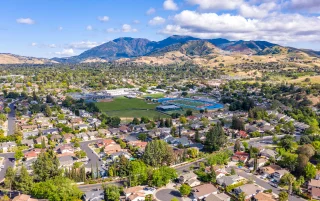 Aerial photo over the city of Concord, California with houses in the foreground and green trees, California, USA – Concord, cheap car insurance in California