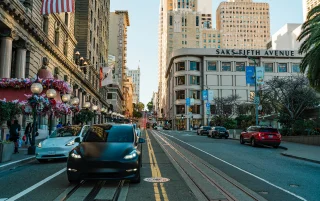 Electric cars and traditional architecture line the street leading up to San Francisco's Union Square, California – San Francisco, cheap car insurance in California