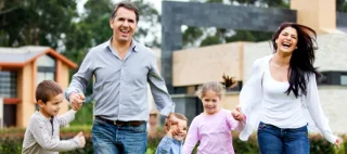 Beautiful family having fun running outdoors and smiling.