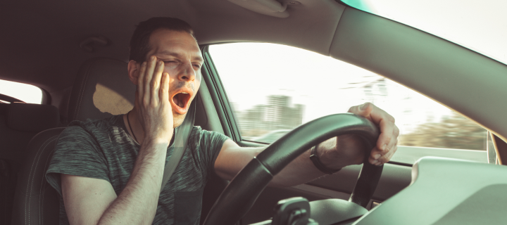 Drunk driver yawning and falling asleep rushes at high speed along road, breaking the rules and speeding violation. Drug intoxication while driving in motion. Problems and risk of accident.