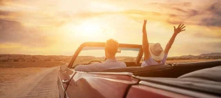 happy people traveling in classic vintage car, couple during honeymoon